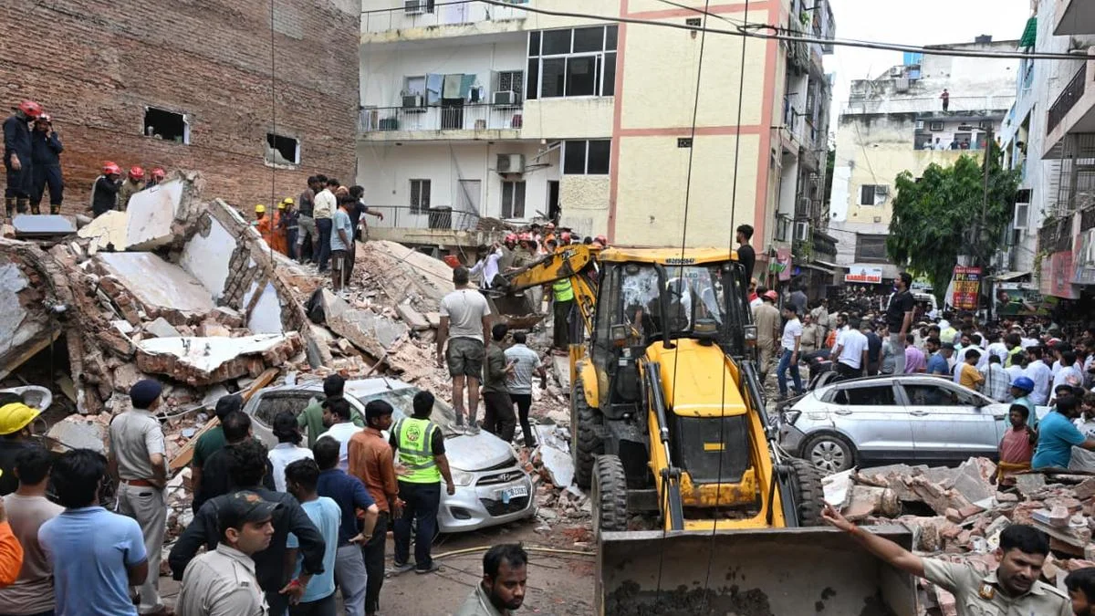NDRF and fire rescue teams clearing rubble at Satya Niketan hostel collapse site in Delhi